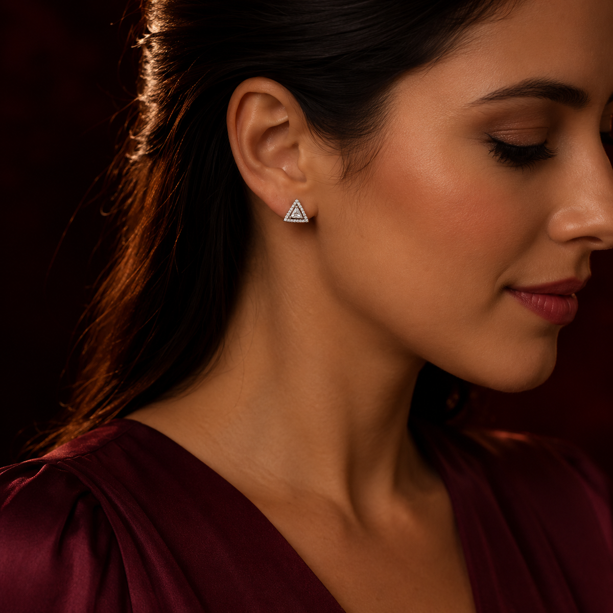 Silver triangular stud earring styled for an evening look
