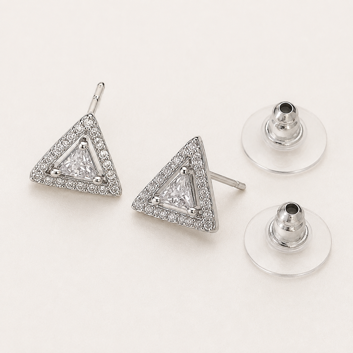 Silver triangular stud earrings and transparent silicone push backs