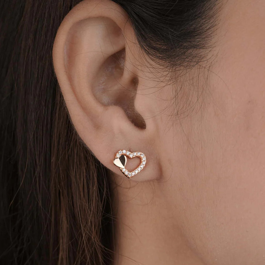 Heart-shaped earring worn by a person with dark hair by Belleza Jewels