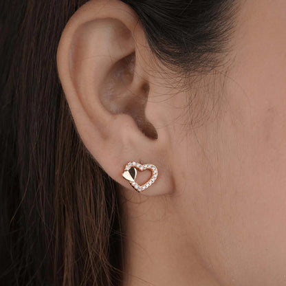 Heart-shaped earring worn by a person with dark hair by Belleza Jewels