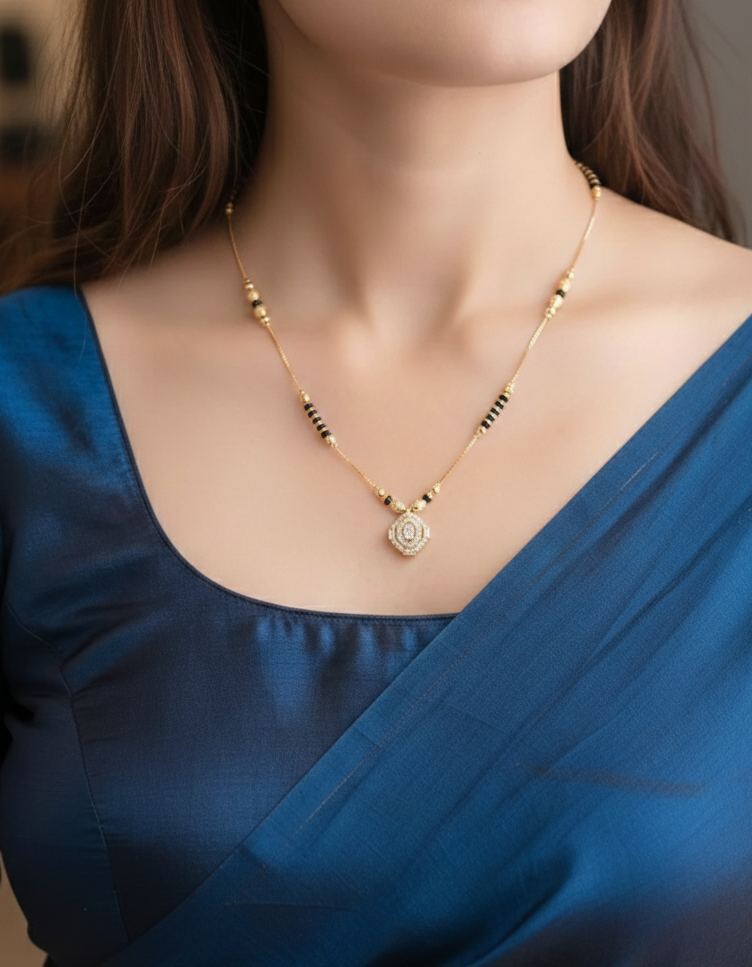 Woman wearing a blue saree with a gold necklace