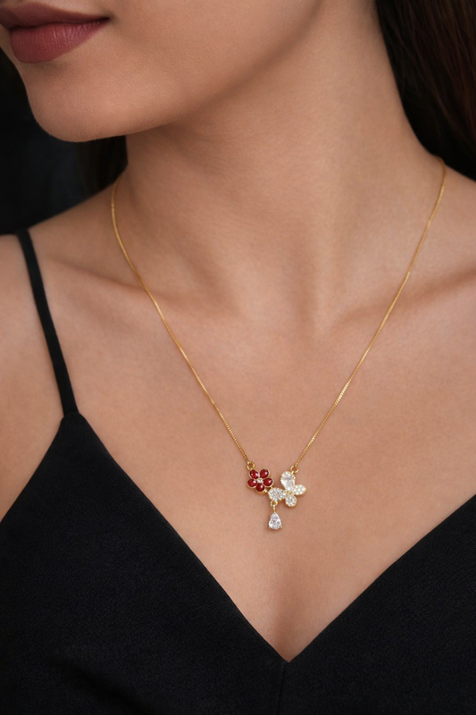 Gold necklace with a pendant worn by a person in a black top