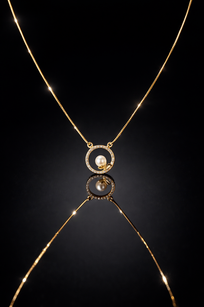 Gold necklace with a pendant on a black background