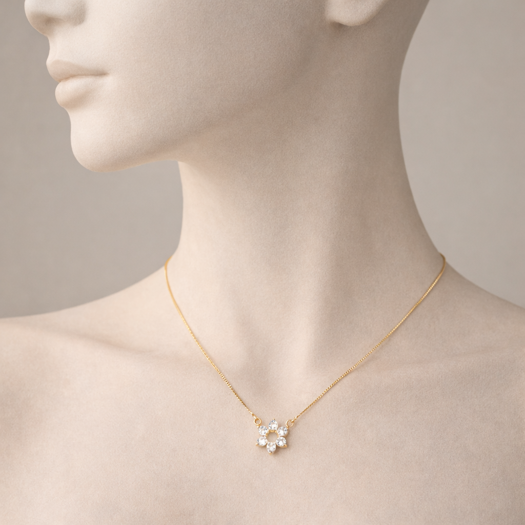 Gold necklace with a floral pendant on a mannequin