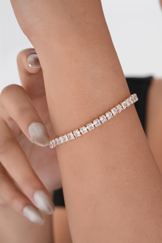 Silver bracelet on a wrist with a blurred background