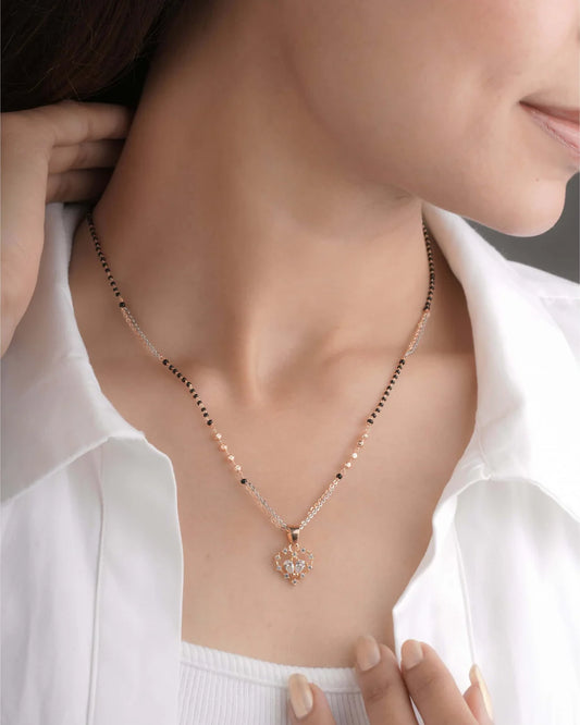 Mangalsutra with a heart pendant worn by a person in a white shirt - Belleza Jewels