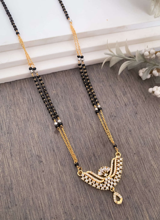 Fancy High Gold American Diamond Royal Delicate Mangalsutra with black and gold chain on wooden background.