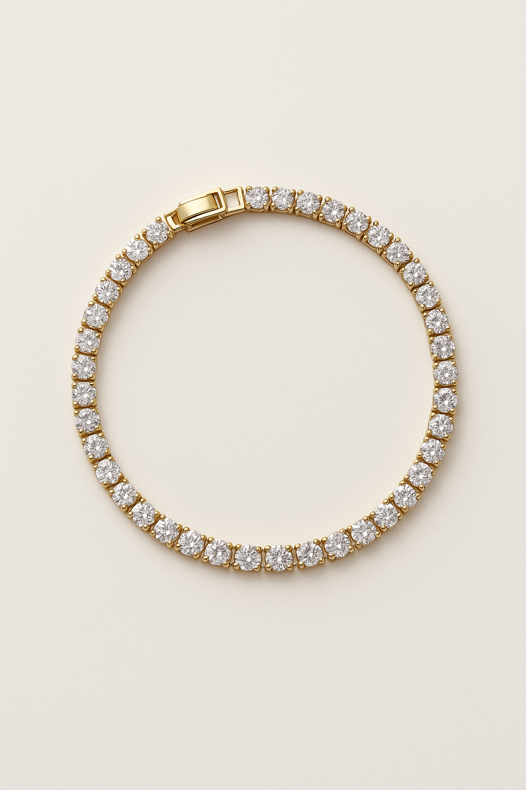 Gold bracelet with clear gemstones on a beige background