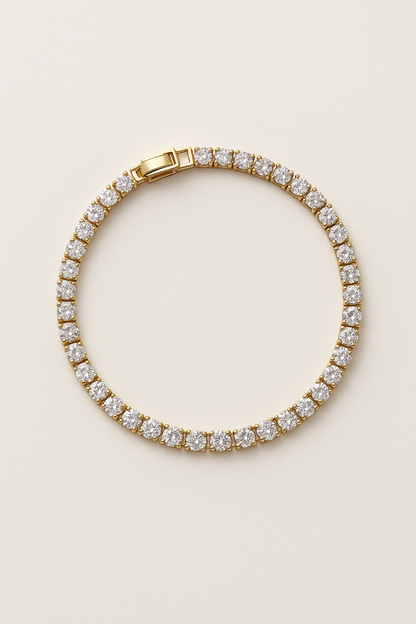 Gold bracelet with clear gemstones on a beige background