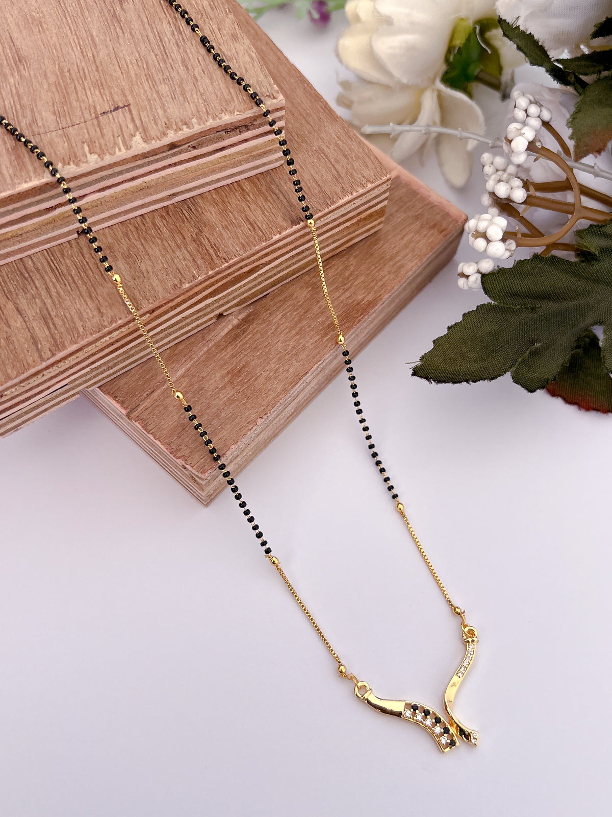 Elegant Black Bead Gold-Tone Mangalsutra with Curved AD Pendant