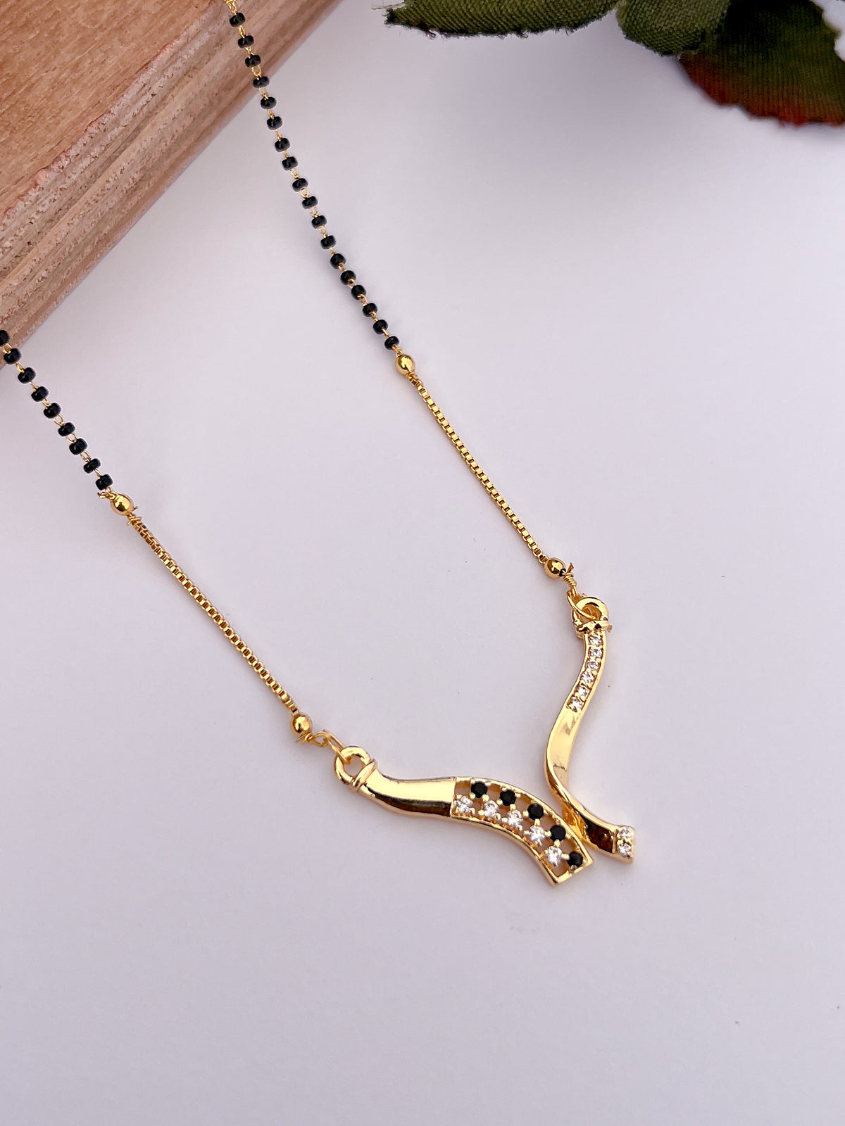 Elegant Black Bead Gold-Tone Mangalsutra with Curved AD Pendant