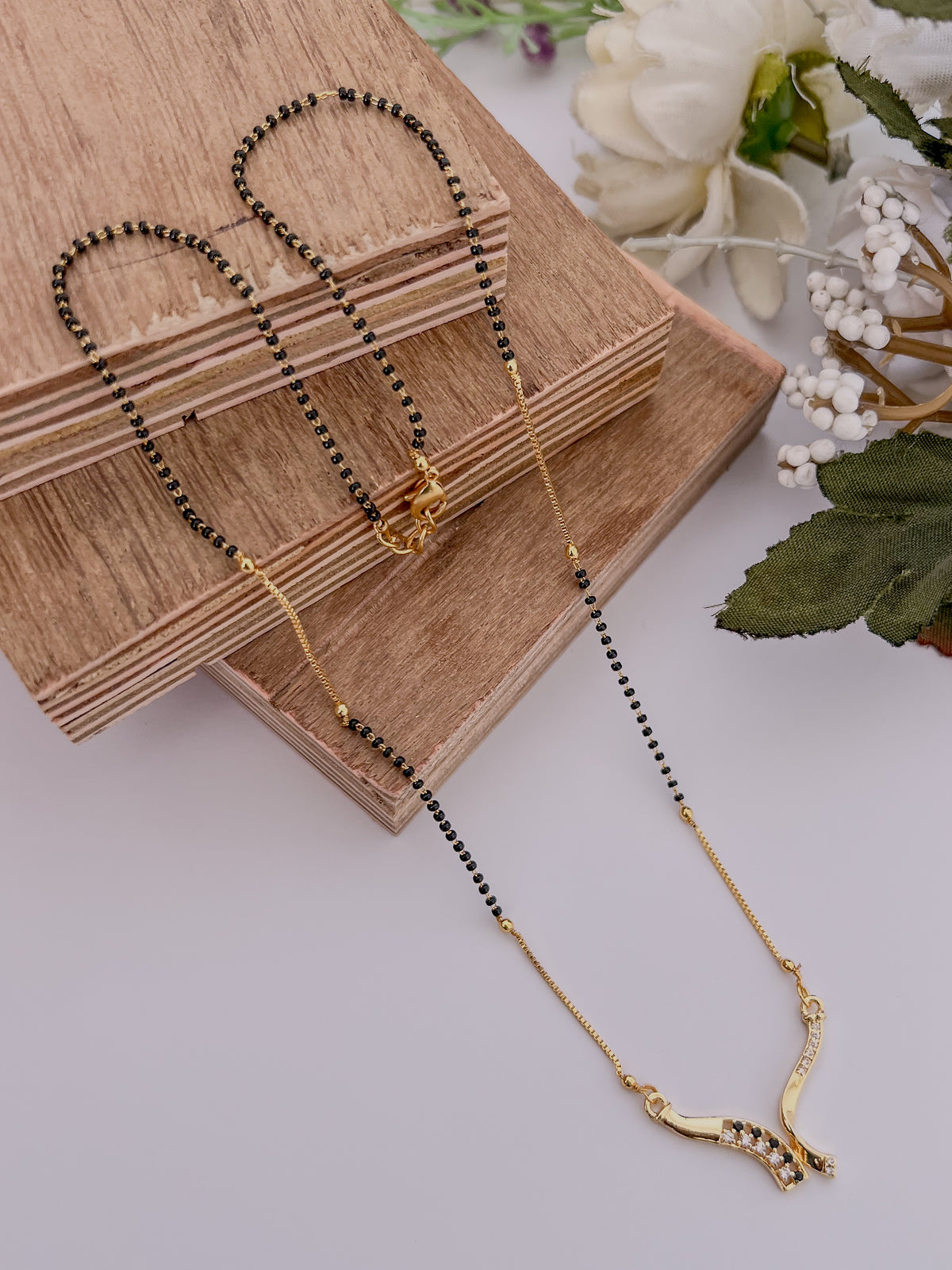 Elegant Black Bead Gold-Tone Mangalsutra with Curved AD Pendant
