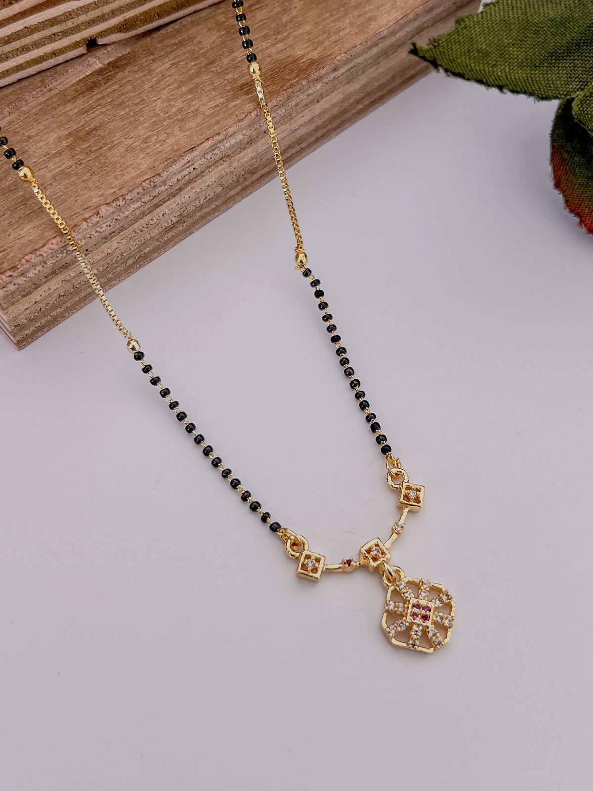 Geometric Floral Black Bead Mangalsutra with Pink Stone Accents