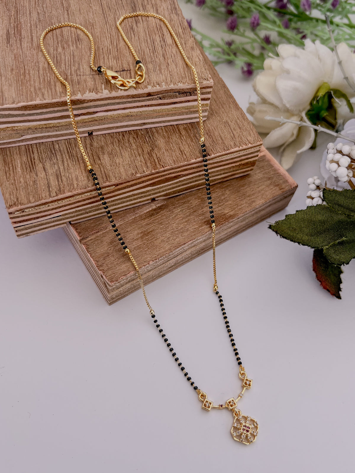 Geometric Floral Black Bead Mangalsutra with Pink Stone Accents
