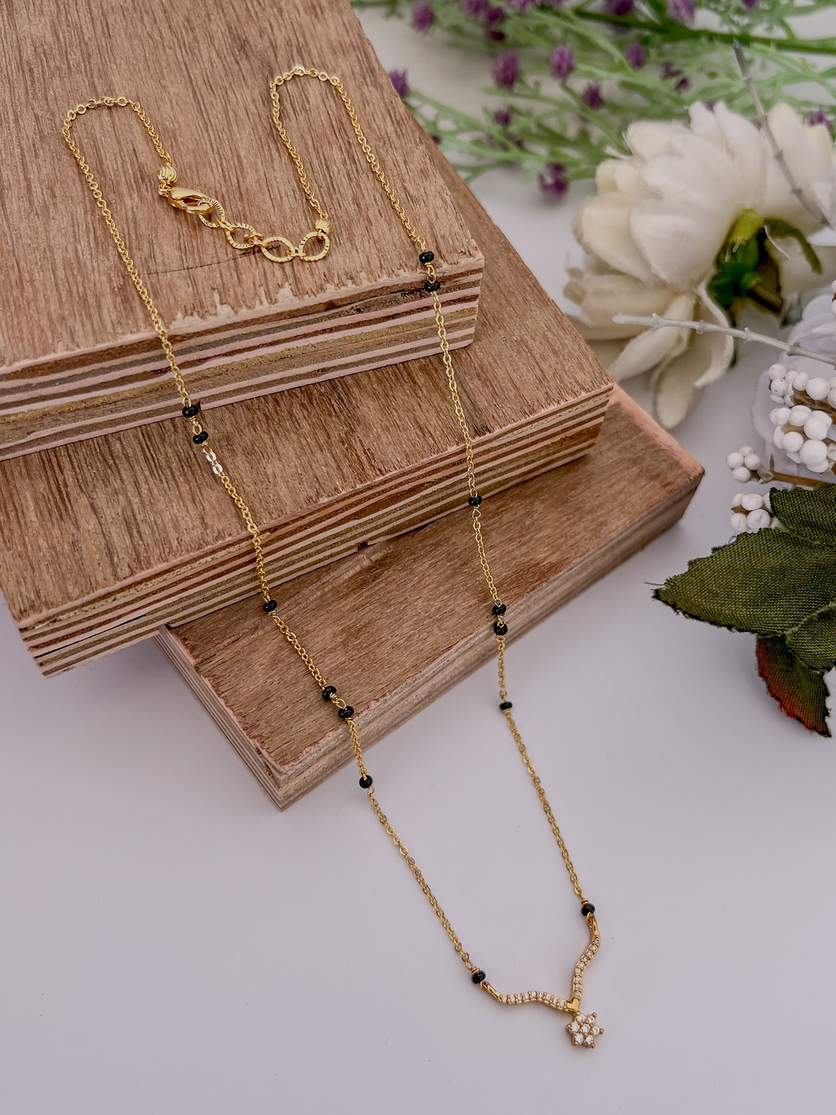 Floral Curve Black Bead Mangalsutra with Sparkle Drop
