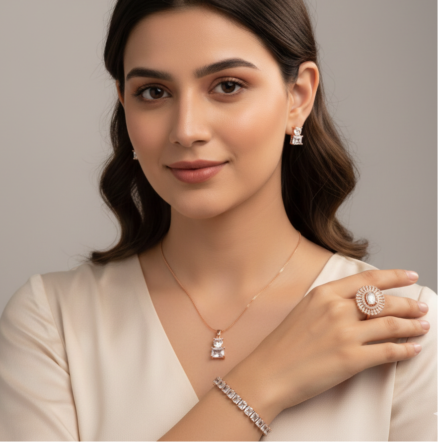 Woman wearing jewelry including a necklace, ring, and bracelet against a neutral background | Belleza Jewels