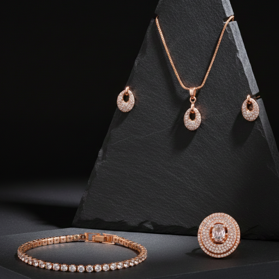 Rose gold jewelry set including necklace, earrings, ring, and bracelet on a black stone stand.