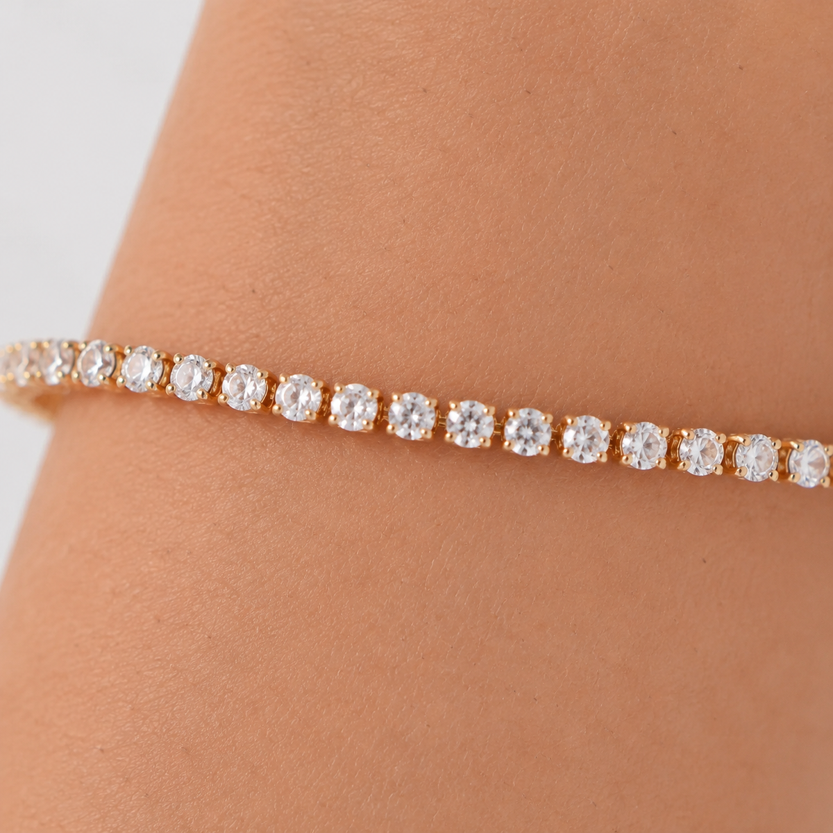 Macro detail of round CZ stones and gold-tone settings