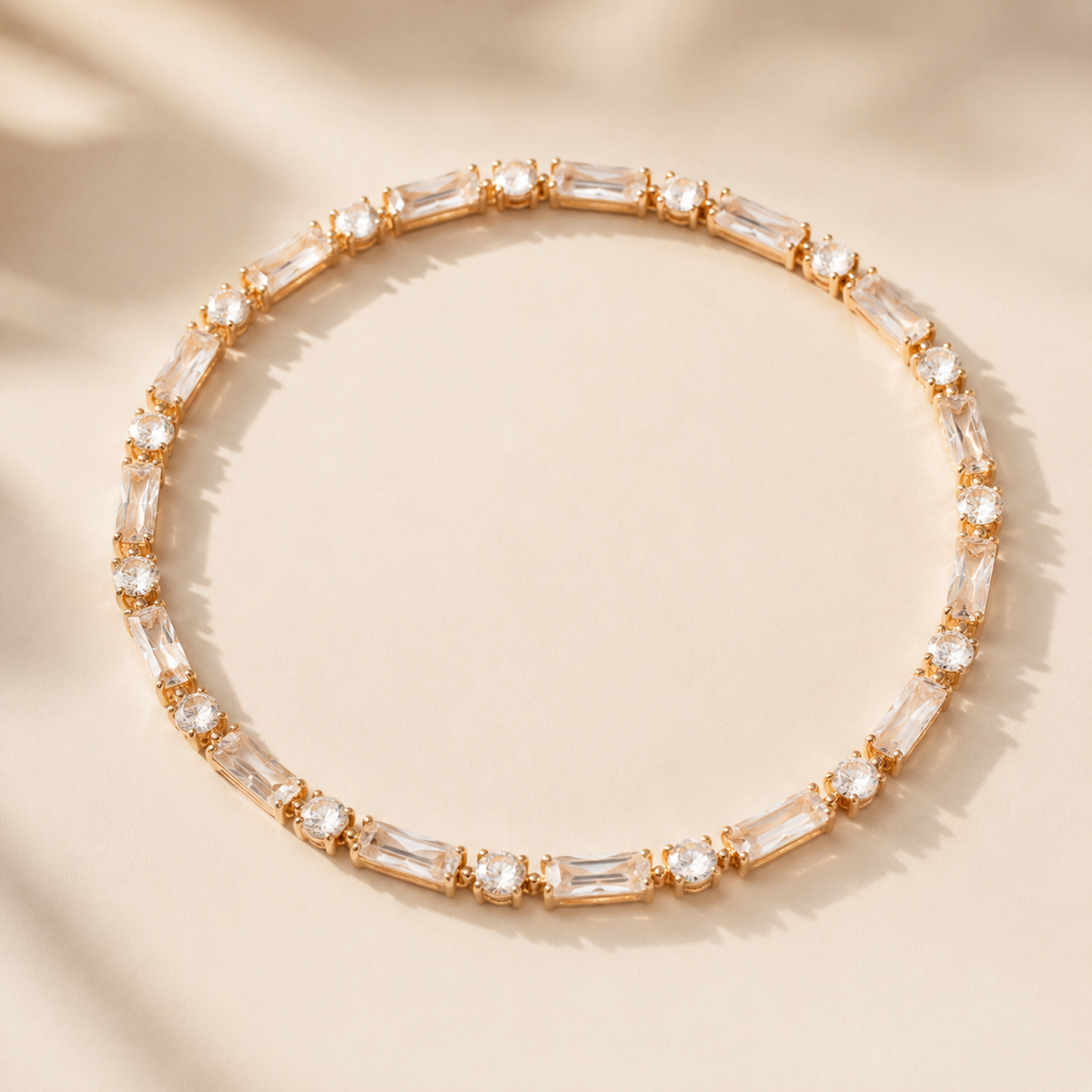 Round Stone Tennis Bracelet in gold with alternating baguette and round stones on warm ivory
