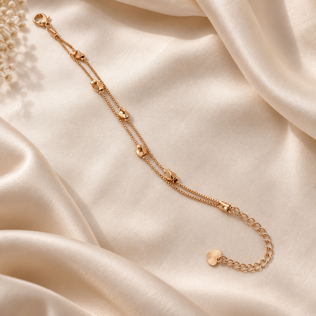 Double-layer gold-tone bracelet styled on soft ivory silk