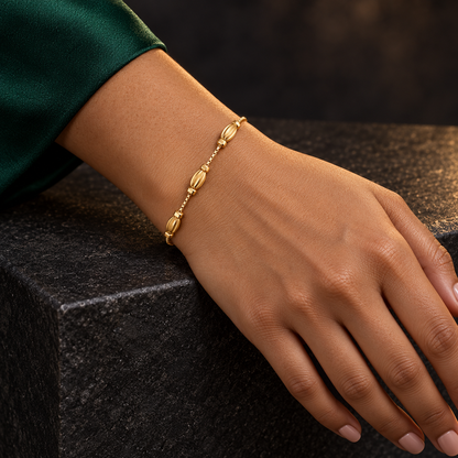 Sculpted oval charm gold-tone bracelet styled for evening wear