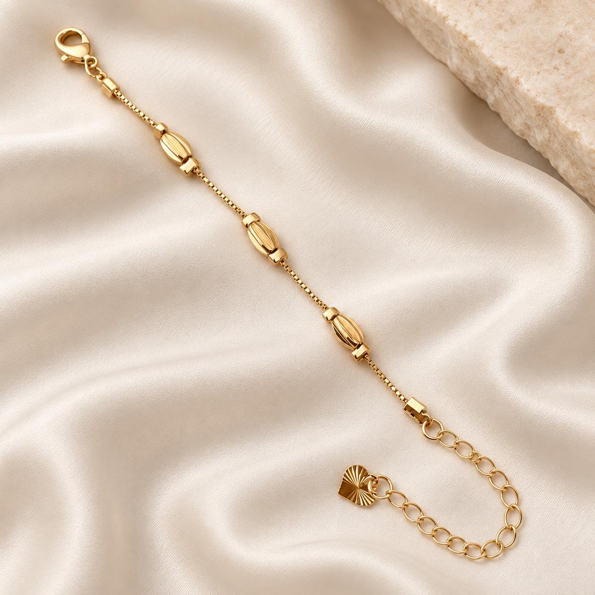 Sculpted oval charm gold-tone bracelet on ivory silk