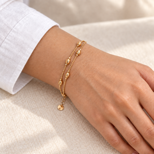 Textured bead double-layer gold-tone bracelet worn on wrist