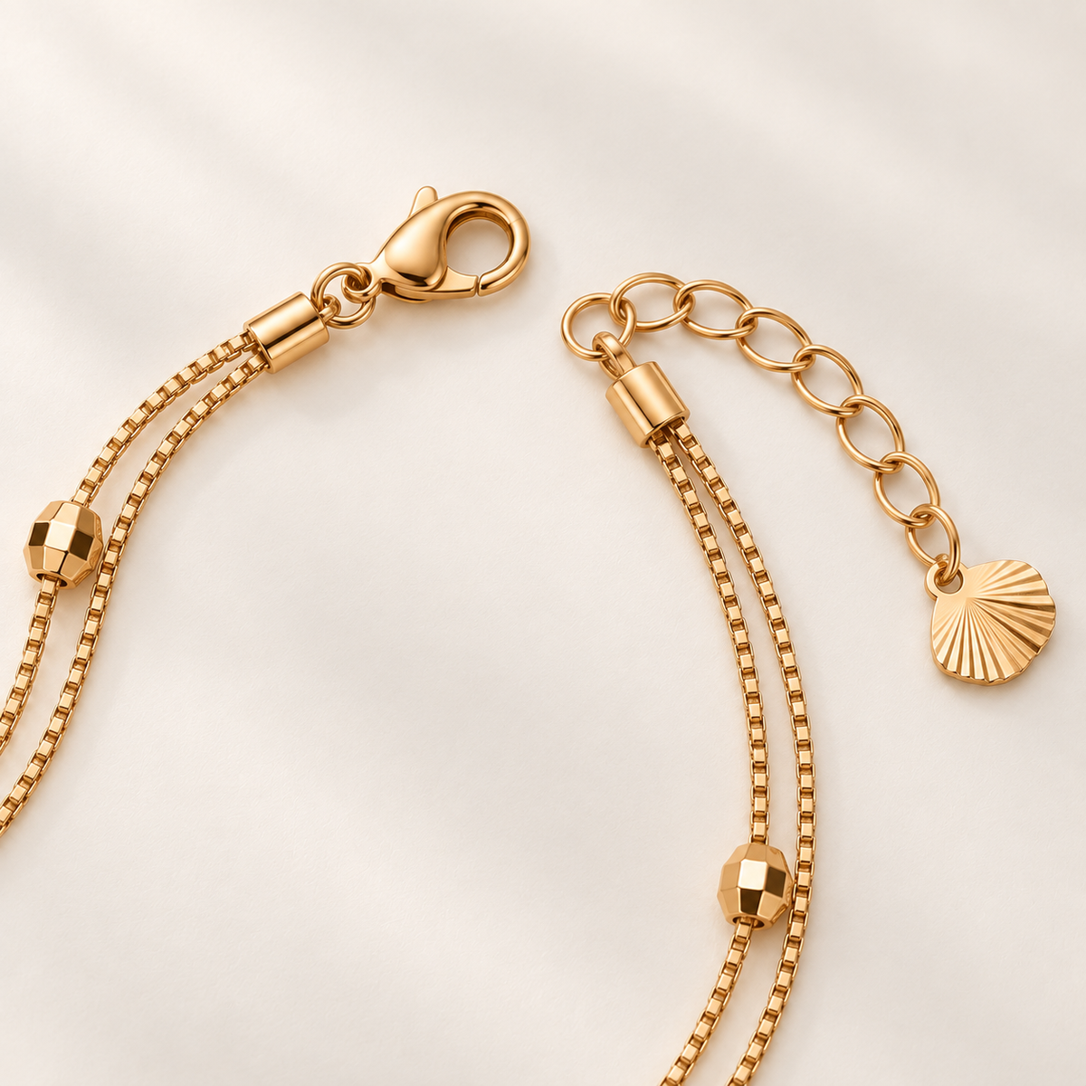 Gold-tone bracelet clasp extender and fan charm detail