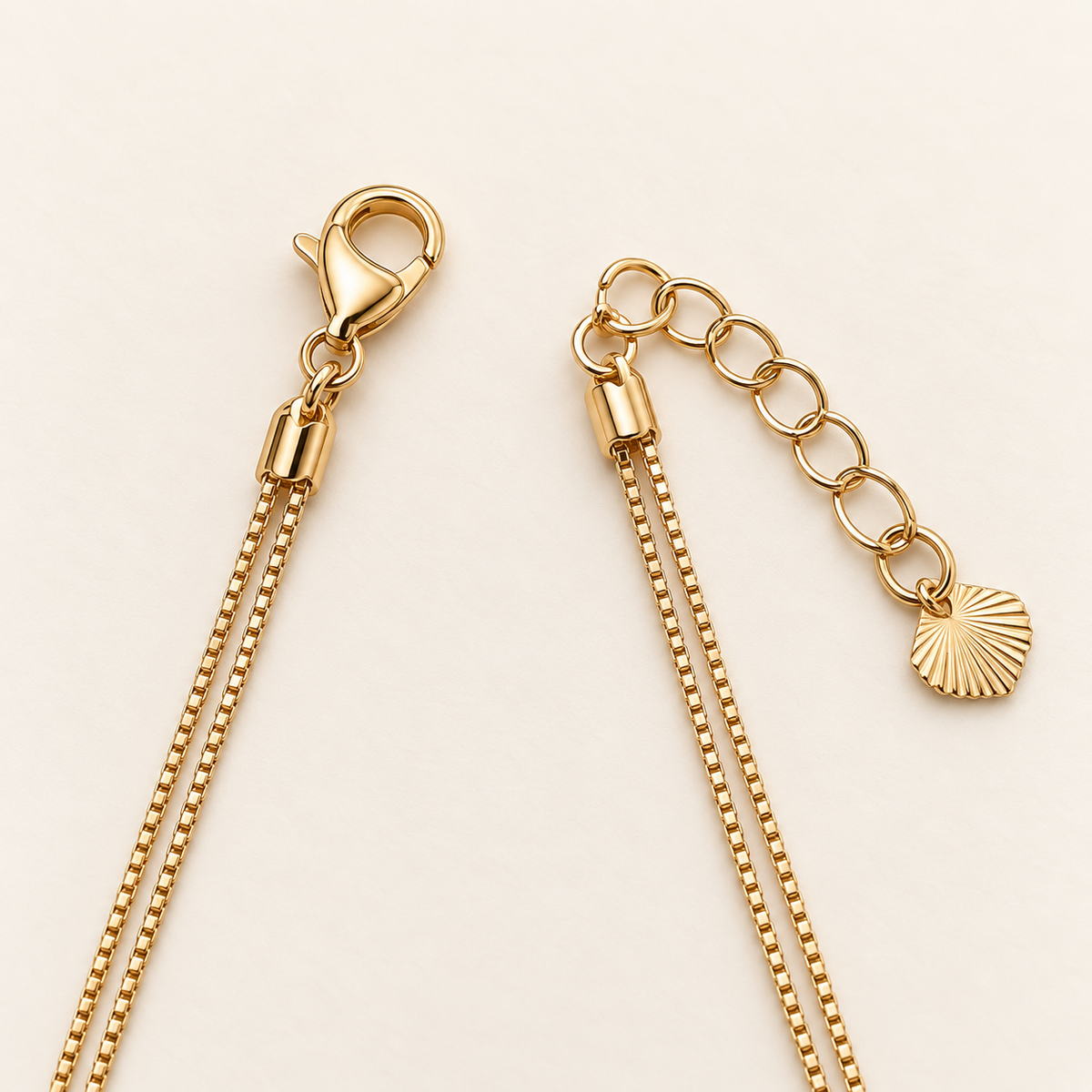 Gold-tone bracelet clasp extender and fan charm detail