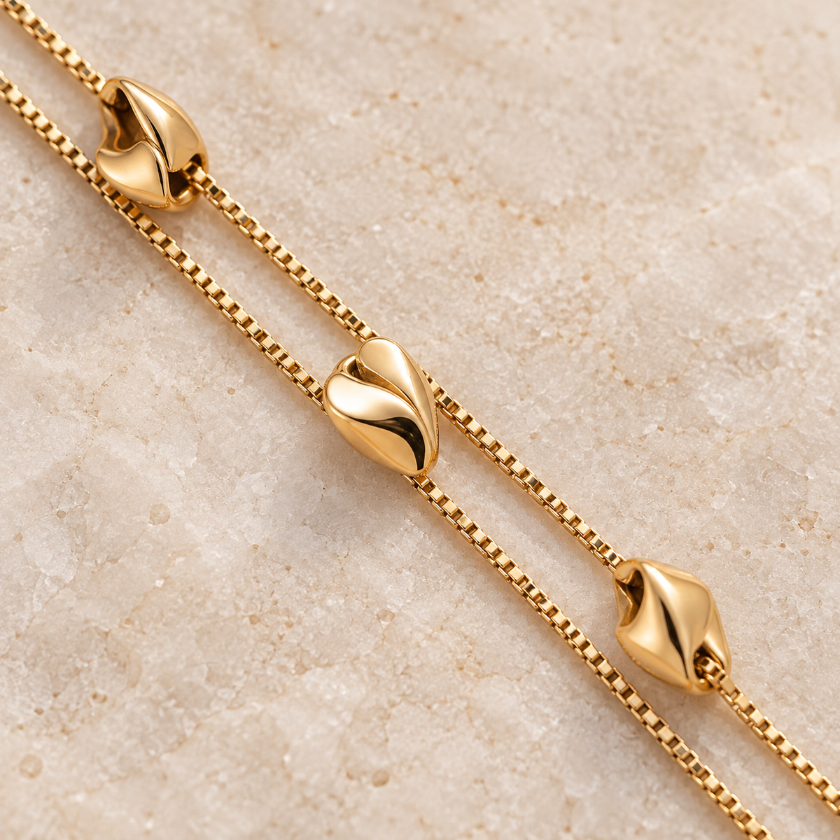 Close-up of polished nugget accents and double gold-tone chains