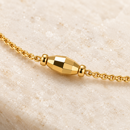 Macro detail of faceted gold-tone bracelet station