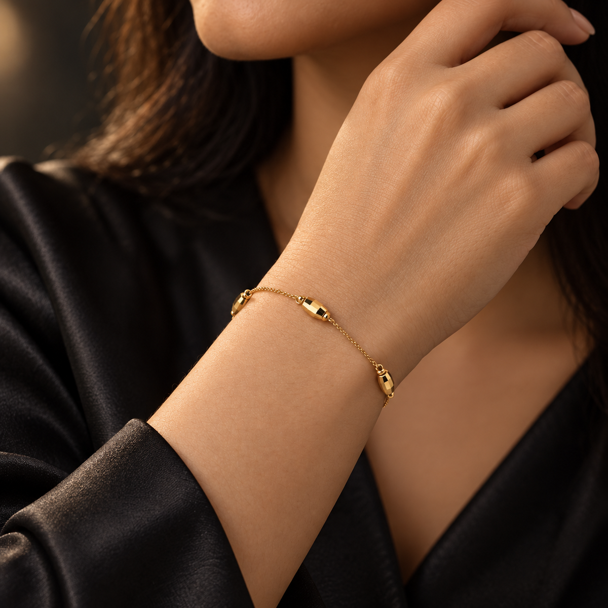 Gold-tone bead chain bracelet styled with black satin